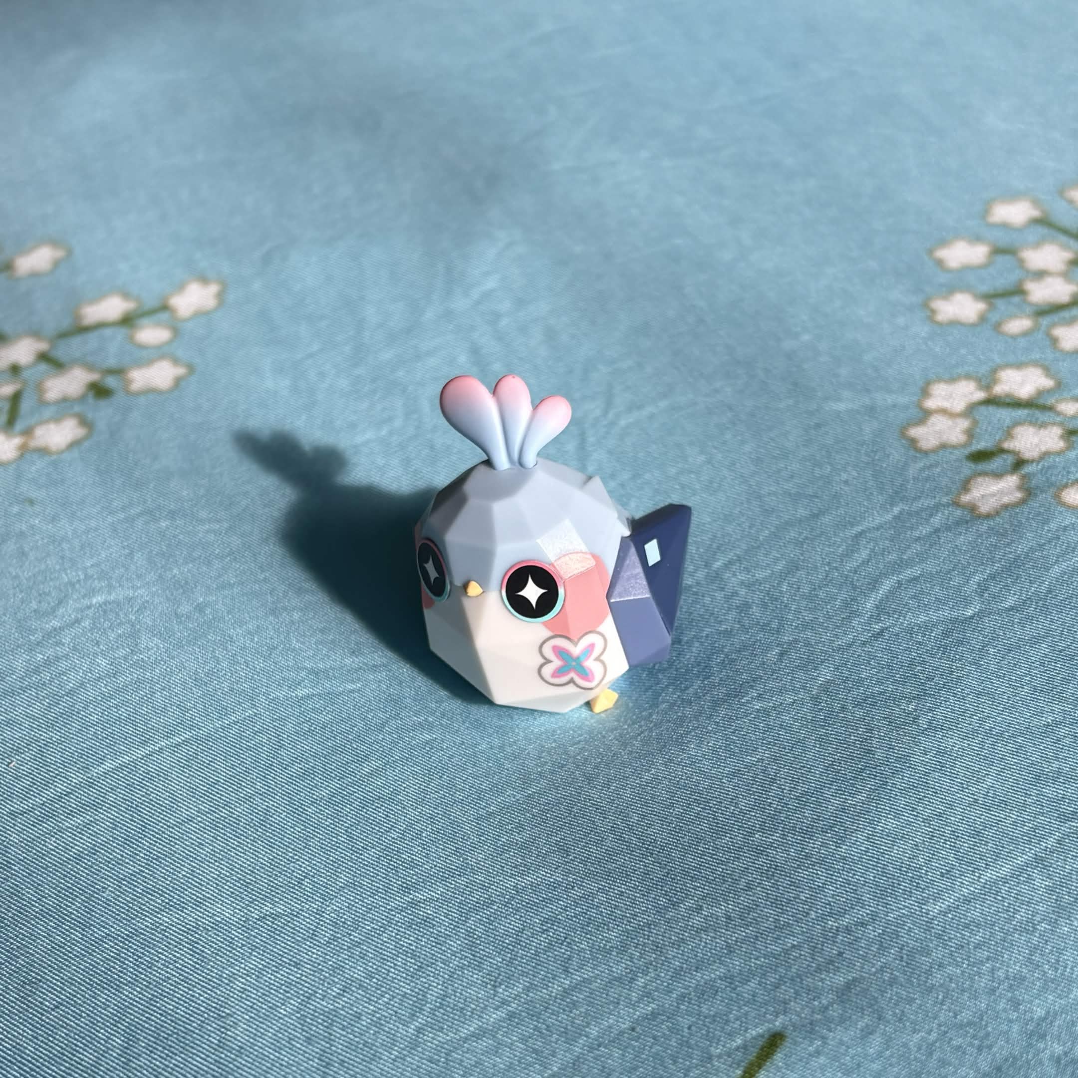 An origami bird figurin from the hitgame Honkai: Star Rail. Its name is March Brid... wait, why name after a month tho?
